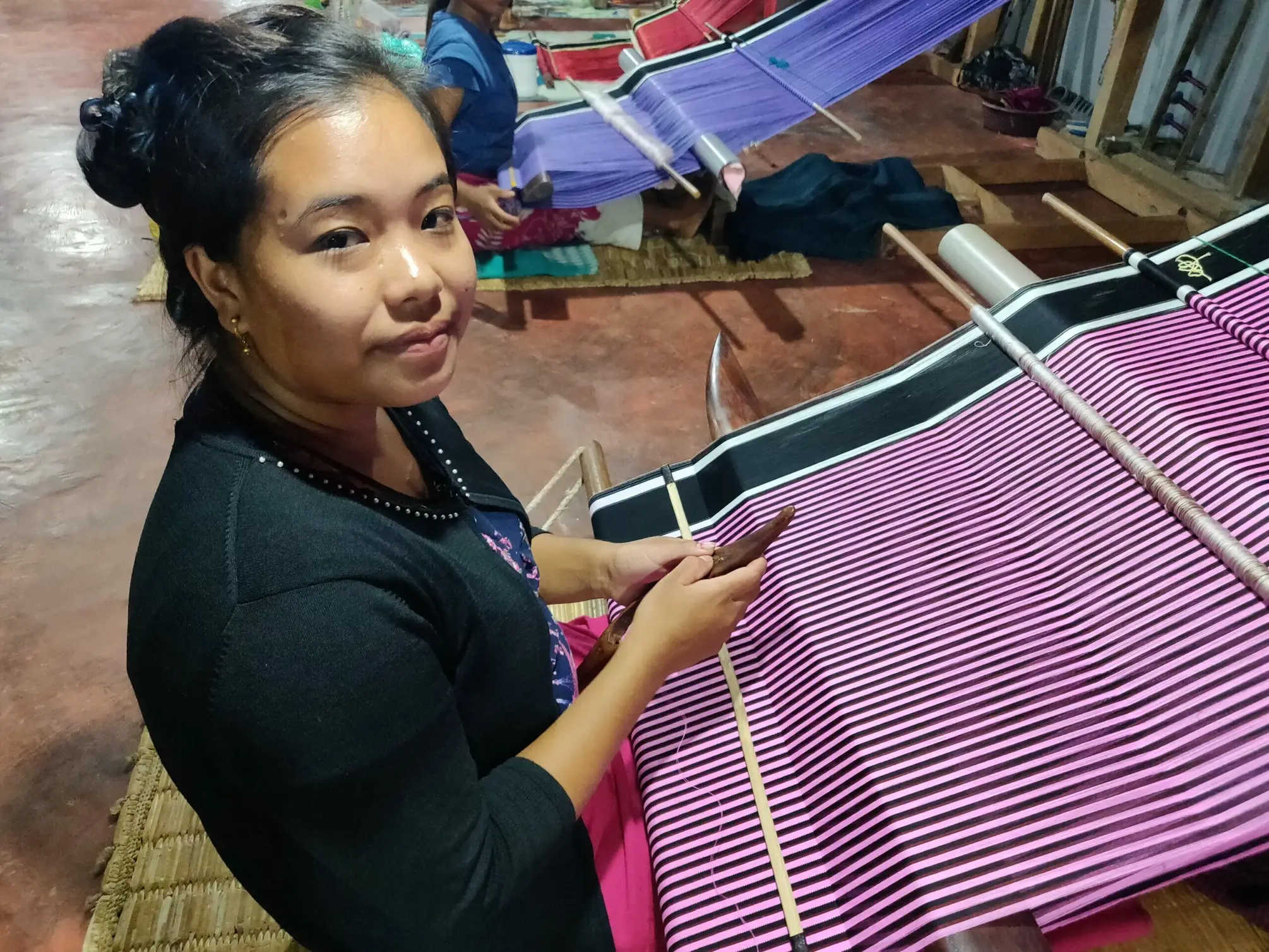A wedding sarong, known as Phanek with the pink stripes being woven on a back strap loom